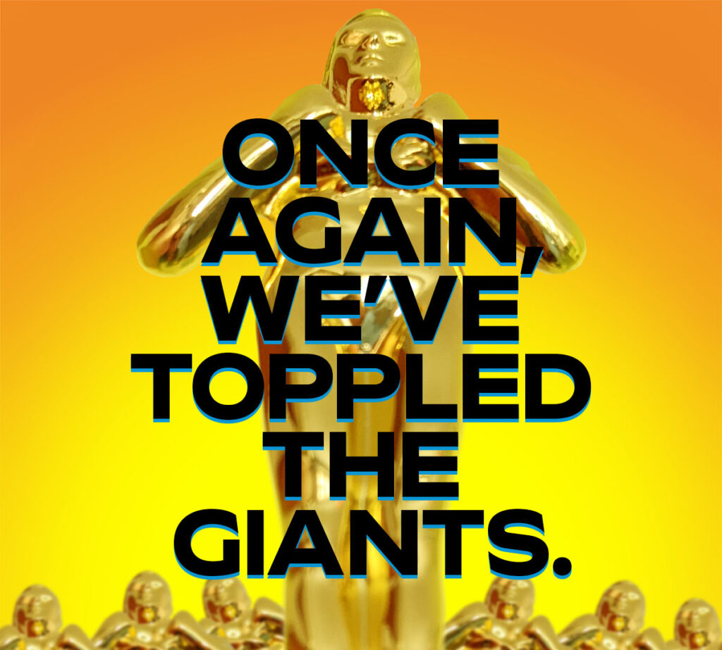 SIAAward trophy at foot perspective, with bright yellow-orange glow background, and overlayed text that reads: Once again, we've toppled the giants.